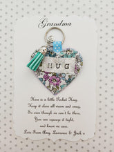 Load image into Gallery viewer, Handmade Pocket Hug heart fabric keyring with tassel - Mint and lilac Floral Print - bag charm - keychain - missing you gift - stay safe gift - BoutiqueCrafts